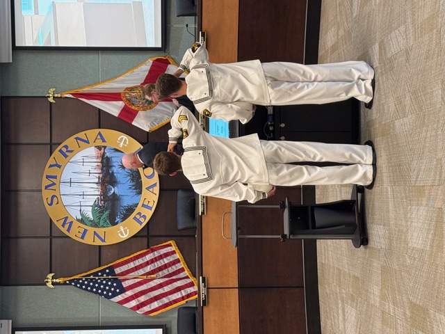 Young residents leading the Pledge of Allegiance at City Commission meeting